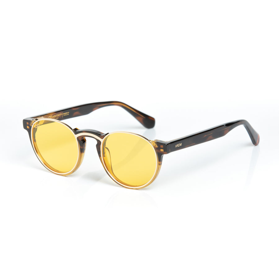 Round sunglasses with yellow lenses and tortoiseshell frame on a white background