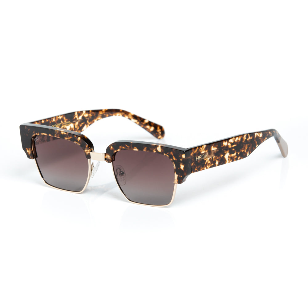 Sunglasses with tortoiseshell frame and dark lenses on a white background