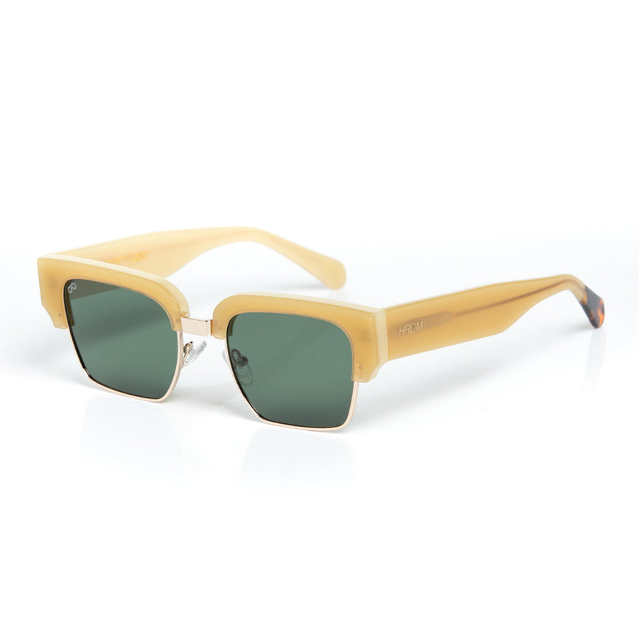 Sunglasses with beige frame and green lenses on a white background