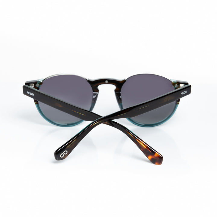 Sunglasses with tortoiseshell frame and dark lenses on a white background