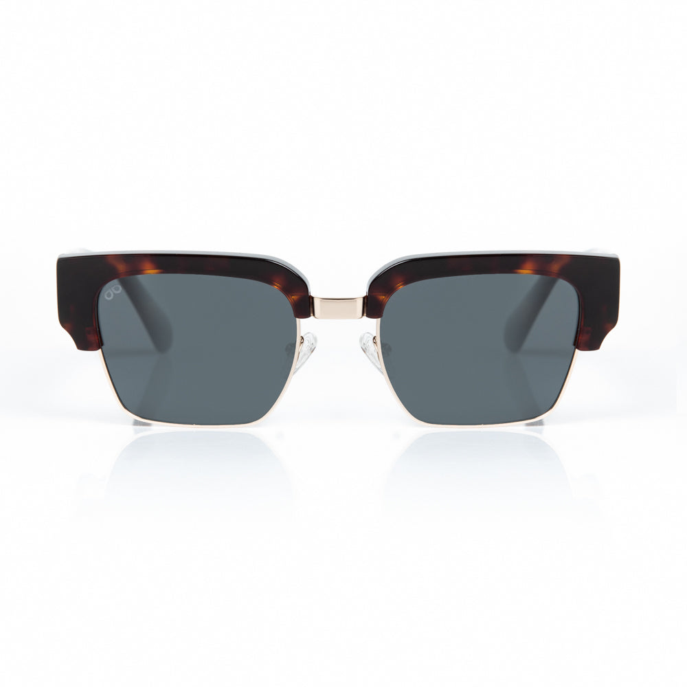 Sunglasses with tortoiseshell frame and dark lenses on a white background