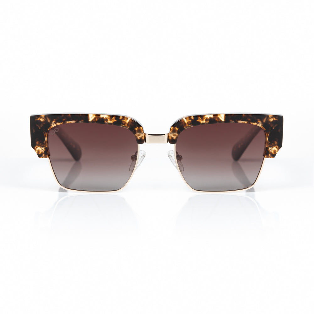 Sunglasses with tortoiseshell frame and brown gradient lenses on a white background