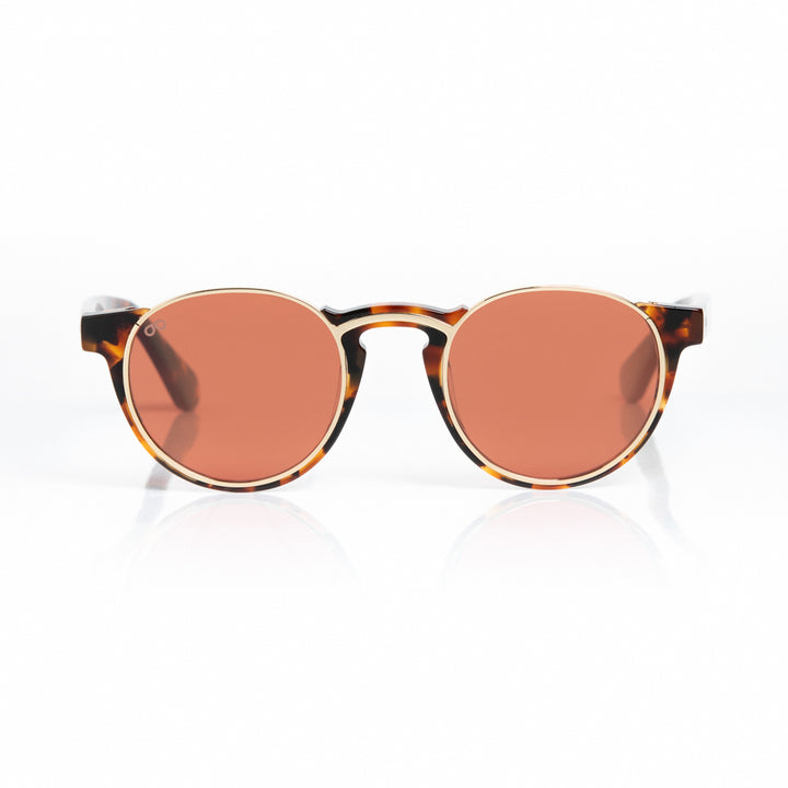 Round sunglasses with tortoiseshell frame and rose gold lenses on a white background