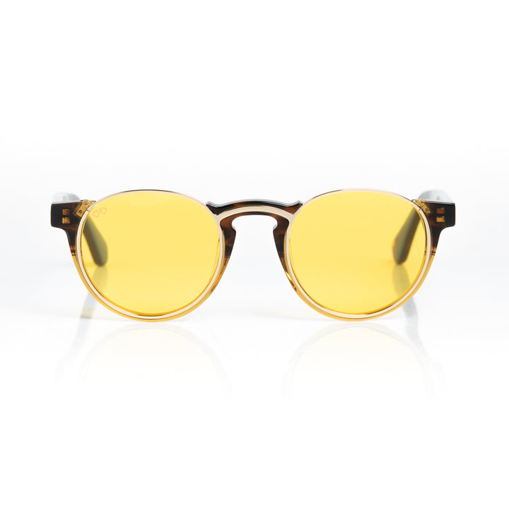 Round sunglasses with yellow lenses and brown frames on a white background