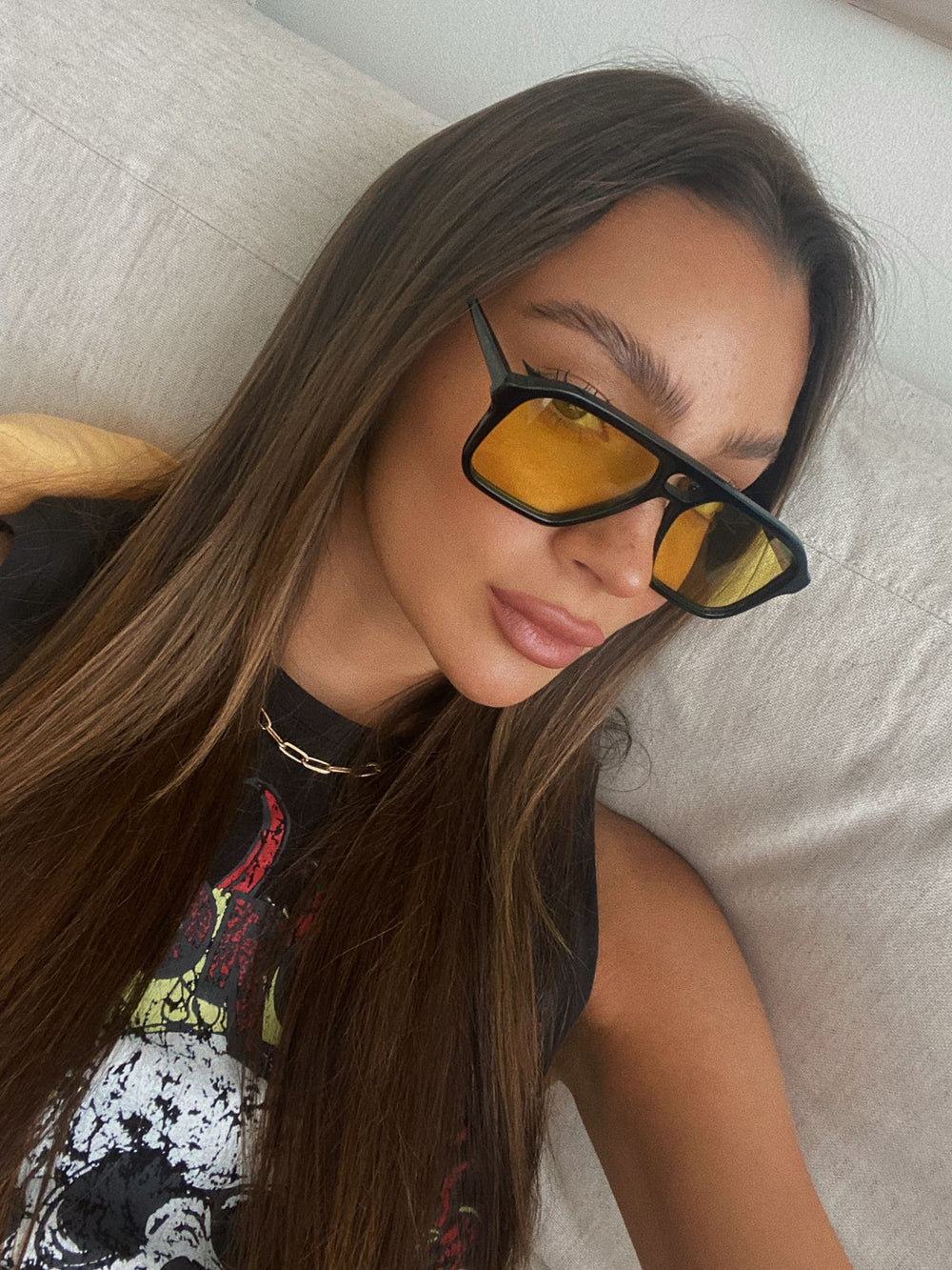 Woman wearing sunglasses with a neutral background