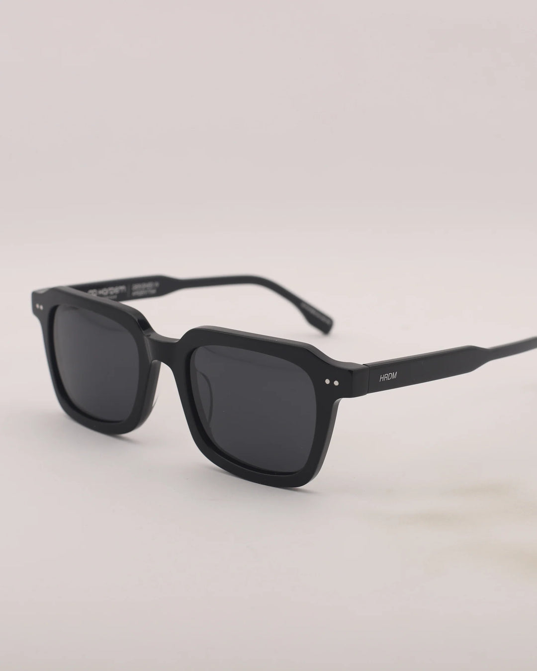 Black sunglasses on a light gray background