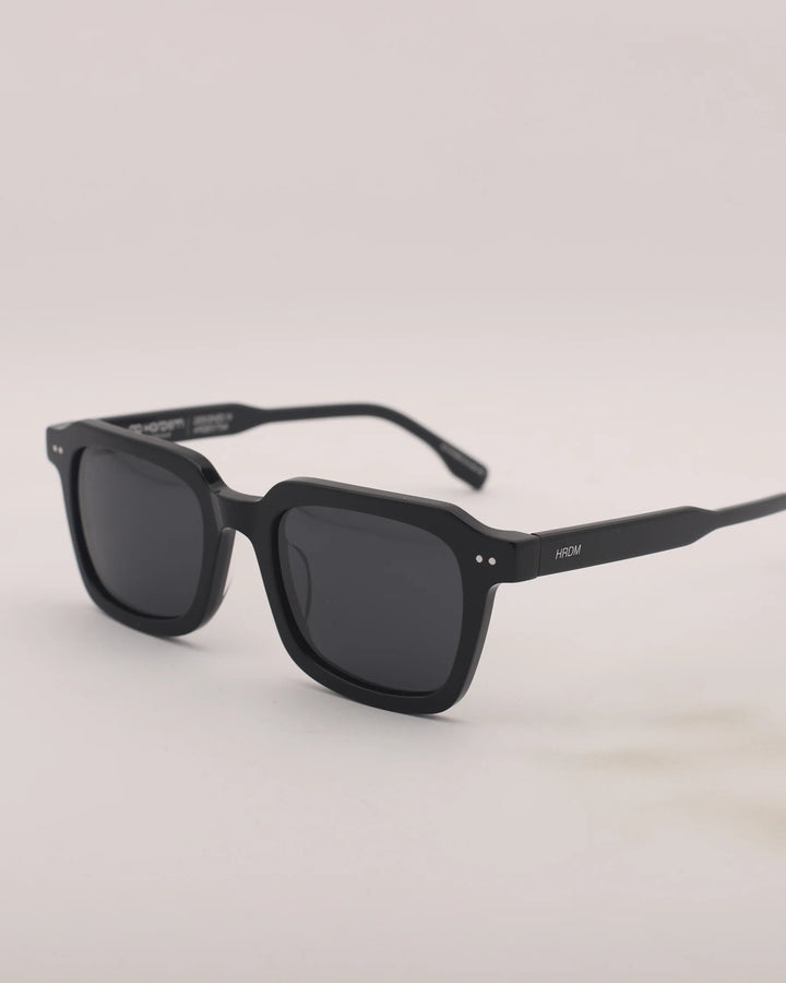 Black sunglasses on a light gray background