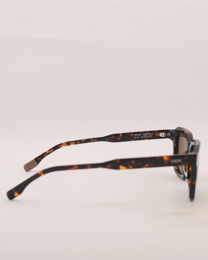 Tortoiseshell eyeglasses on a light gray background