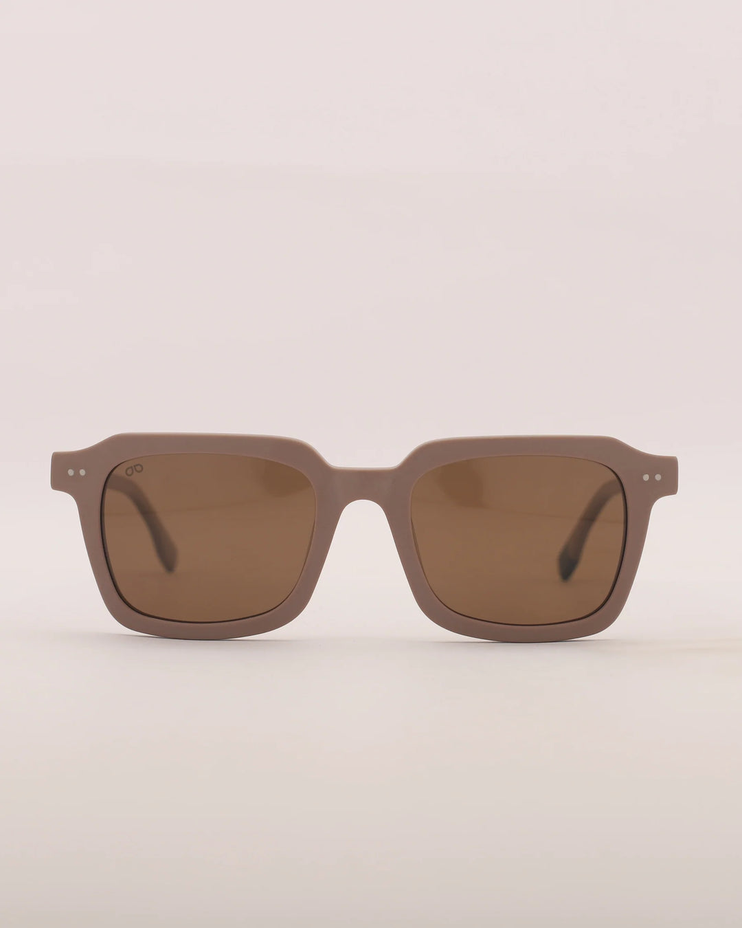 Brown sunglasses on a light beige background