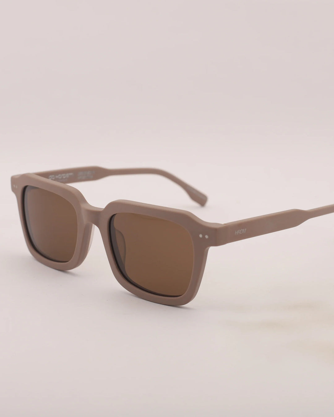 Brown sunglasses on a light gray background