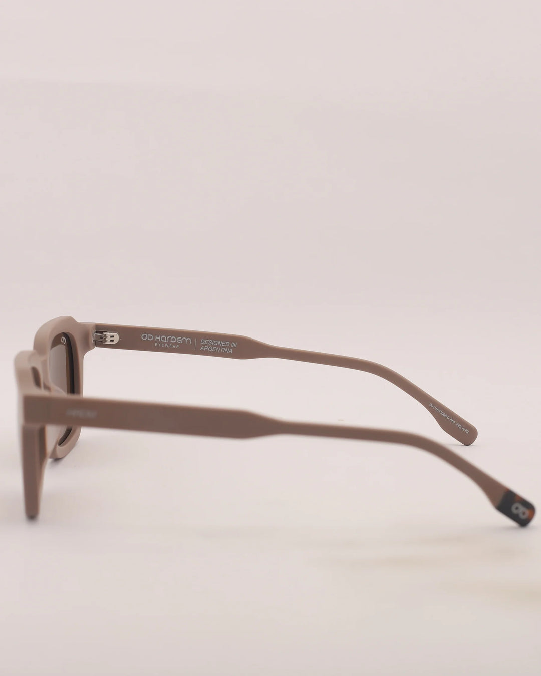 Brown sunglasses on a light beige background