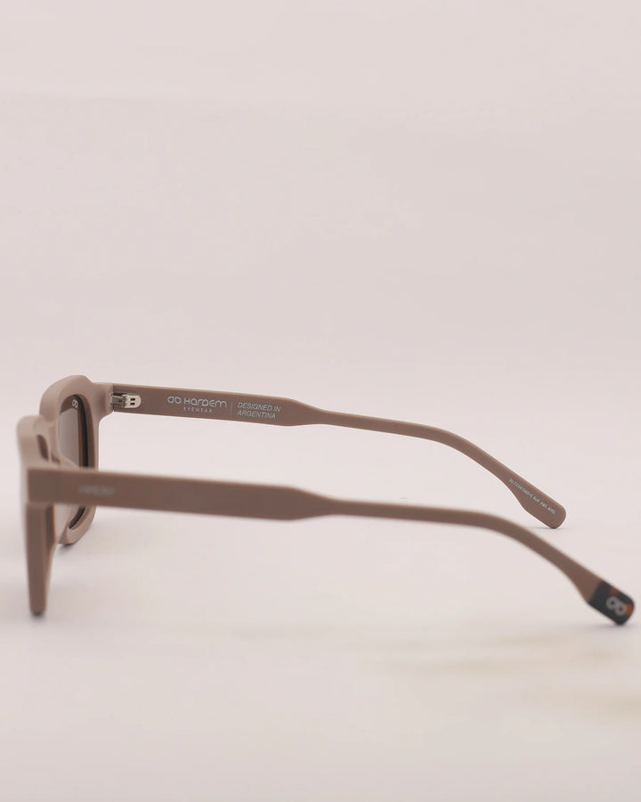 Brown sunglasses on a light beige background
