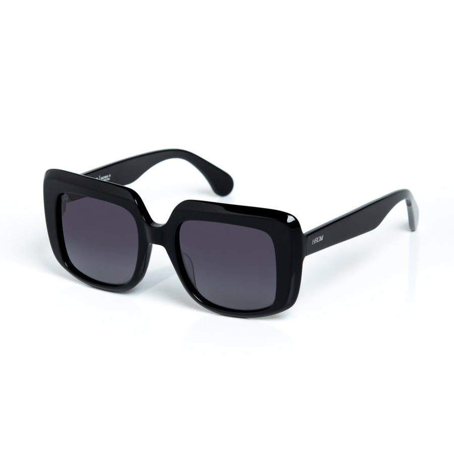 Black sunglasses with dark lenses on a white background
