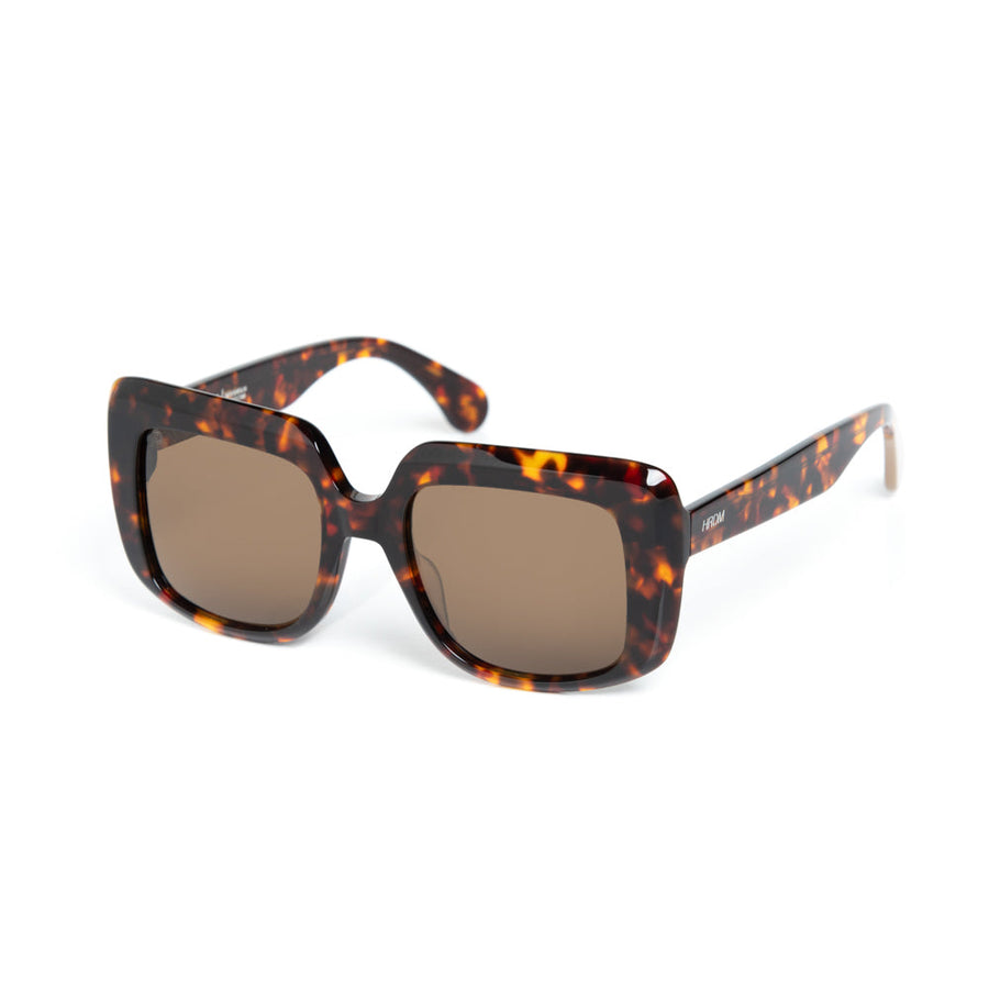 Sunglasses with tortoiseshell frame and brown lenses on a white background