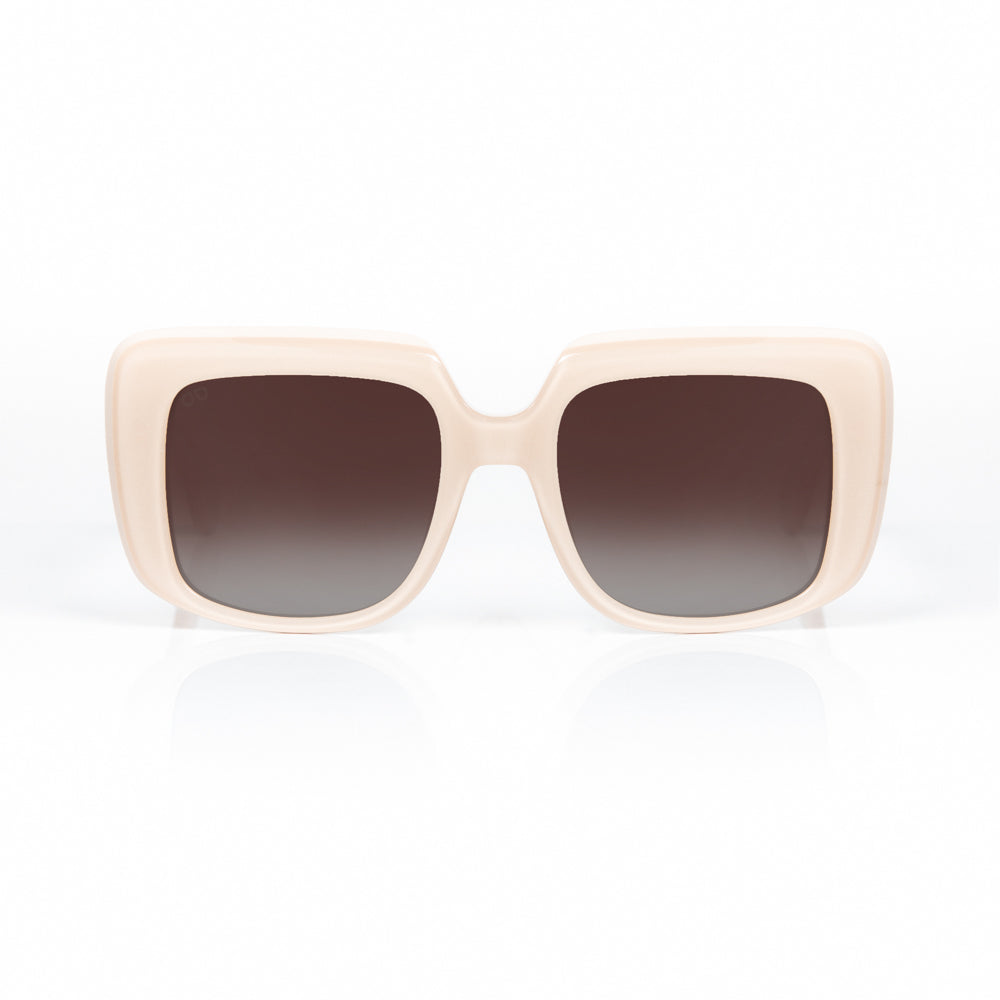 Beige sunglasses with dark gradient lenses on a white background