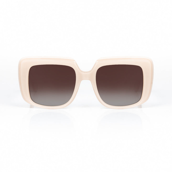 Beige sunglasses with dark gradient lenses on a white background