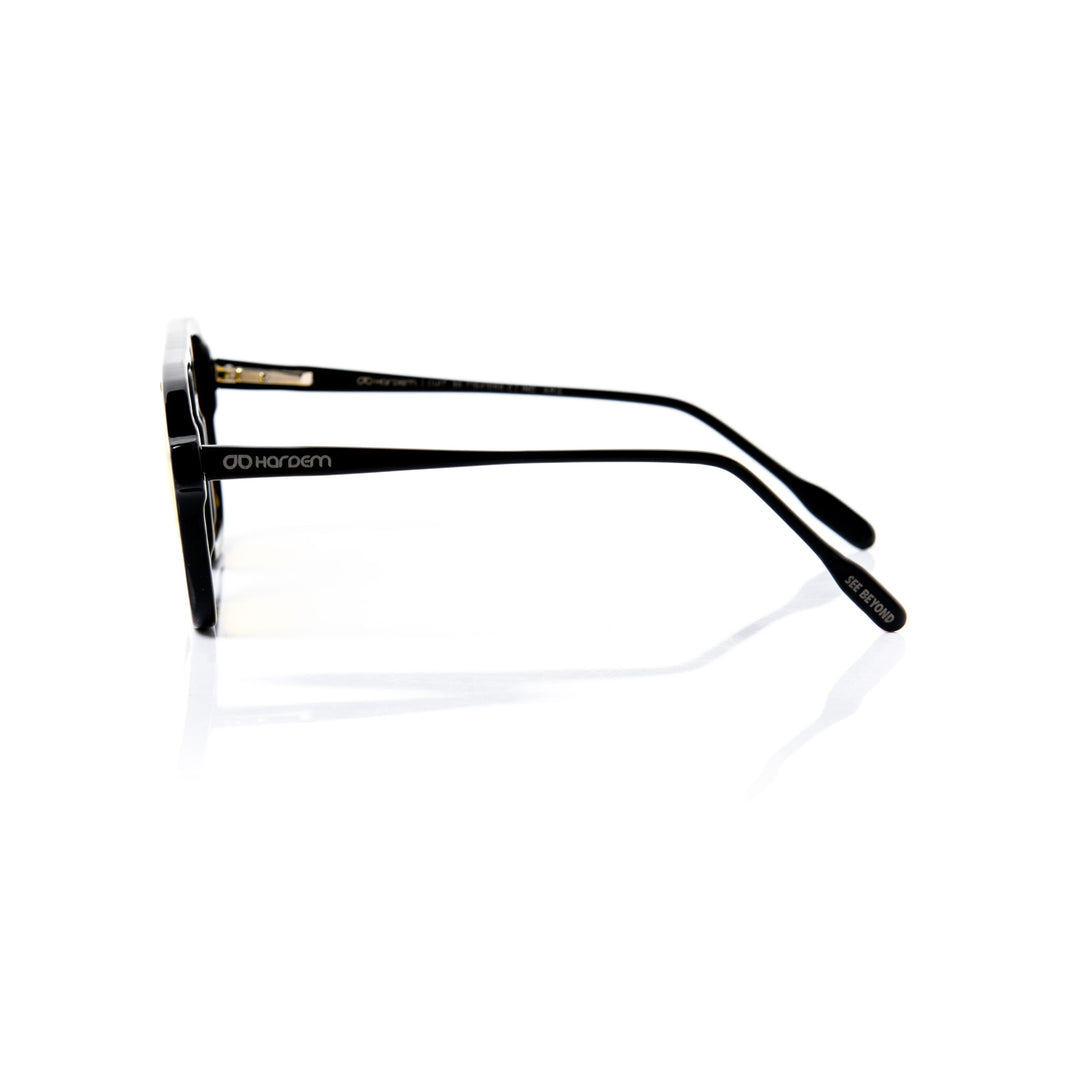 Black eyeglasses with gold accents on a white background