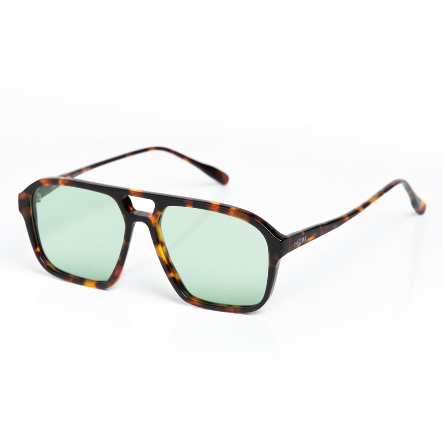Sunglasses with tortoiseshell frame and green lenses on a white background