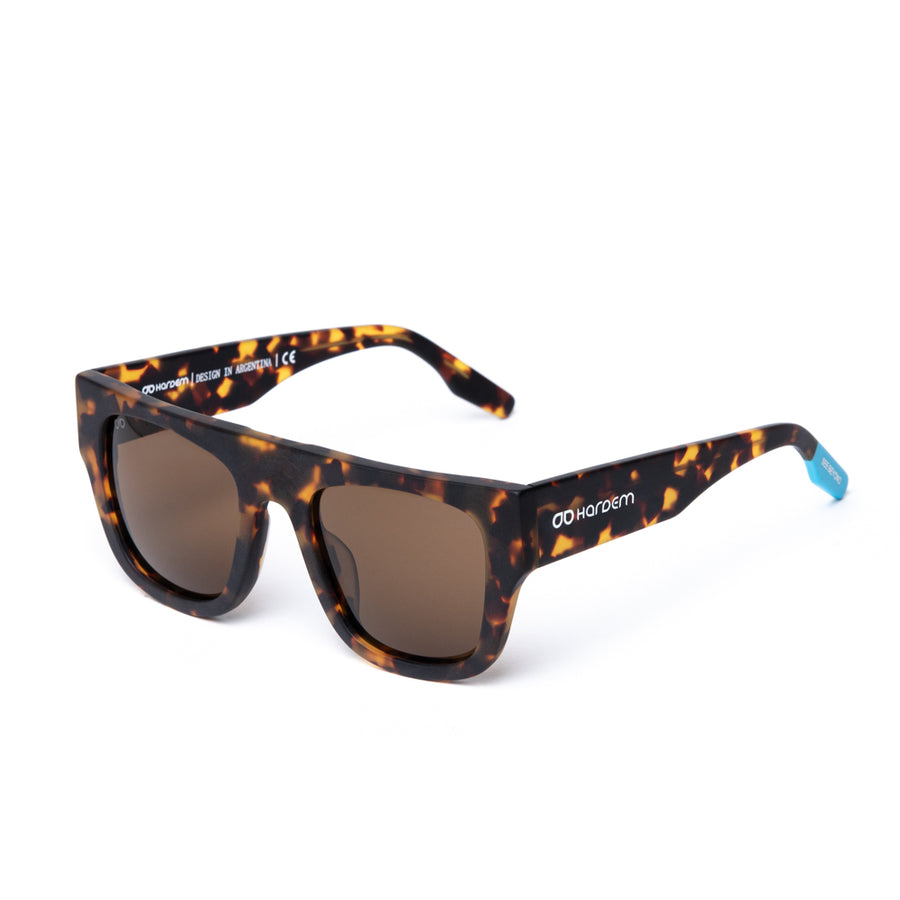Sunglasses with tortoiseshell frame and brown lenses on a white background