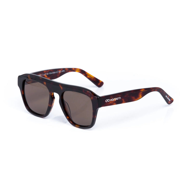 Sunglasses with tortoiseshell frame and dark lenses on a white background