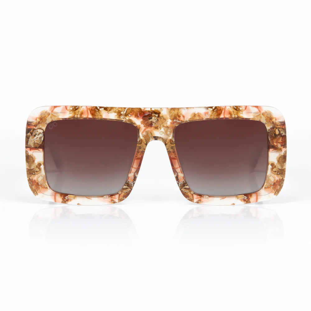 Sunglasses with a marbled frame and brown lenses on a white background