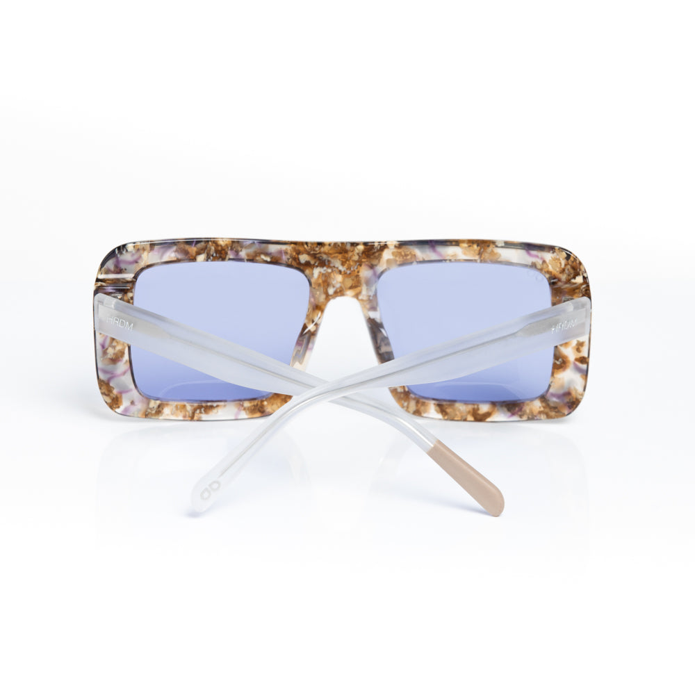 Sunglasses with tortoiseshell frame and blue lenses on a white background