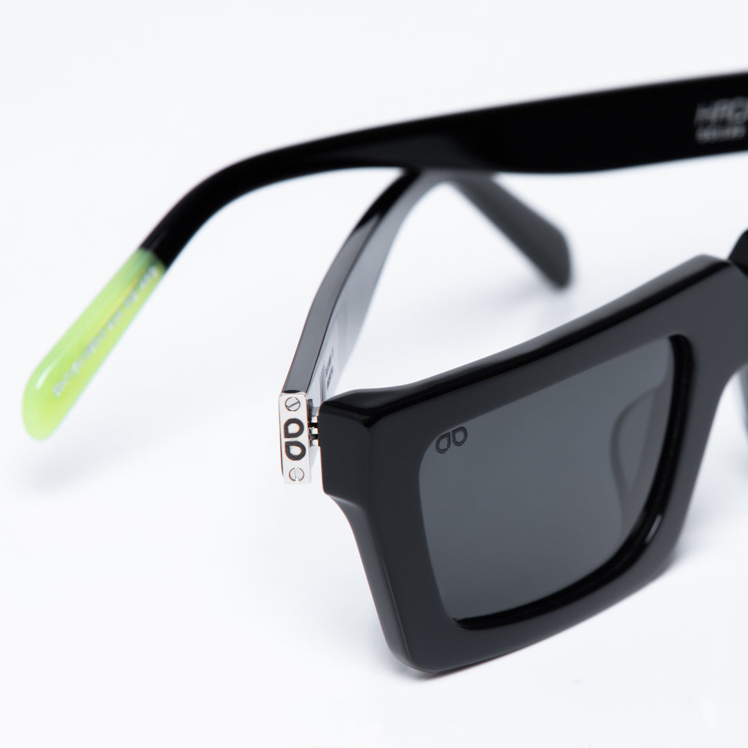 Black sunglasses with a clear lens on a white background