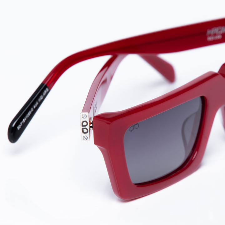 Red sunglasses with a clear lens on a white background
