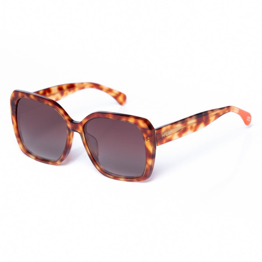 Sunglasses with tortoiseshell frame and dark lenses on a white background