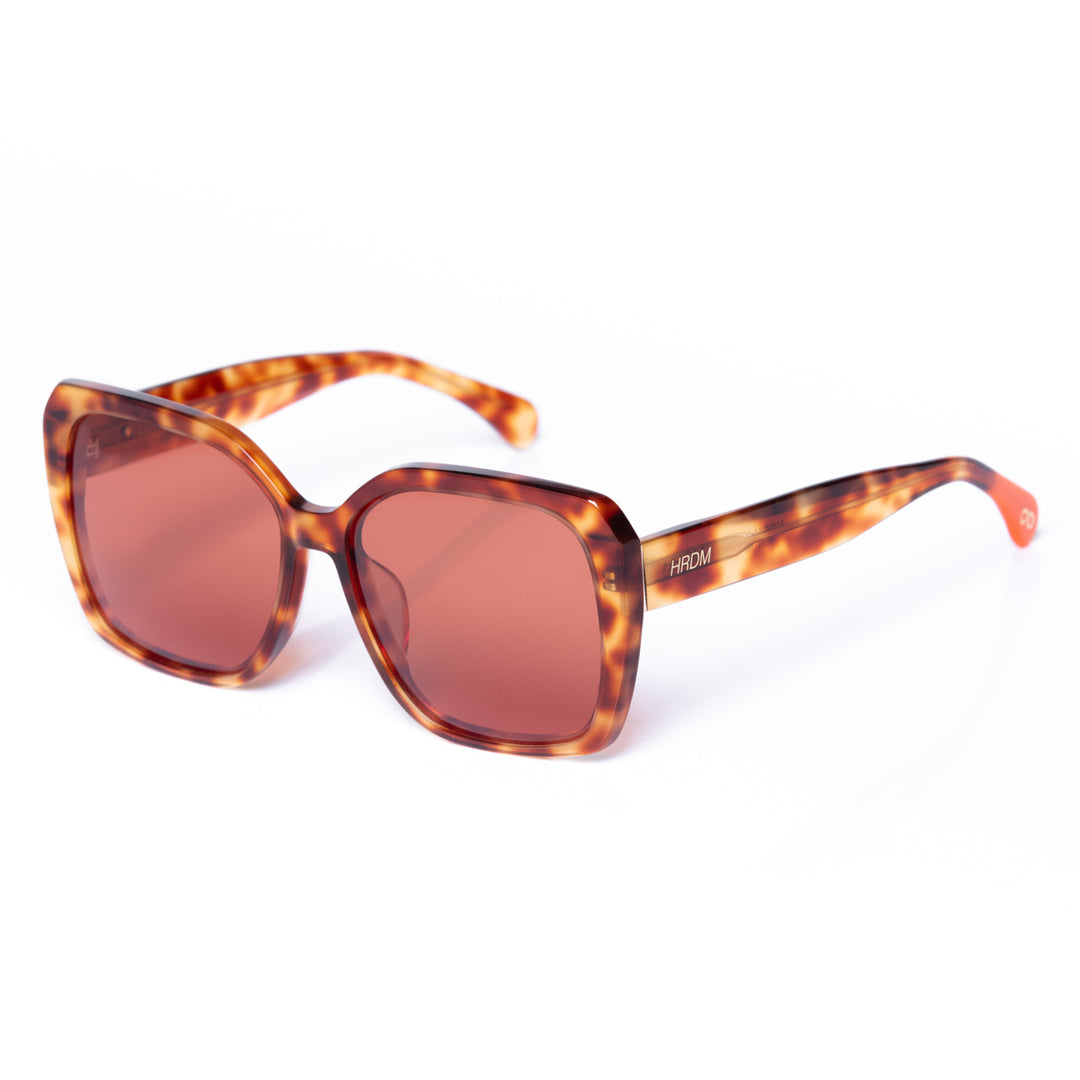 Sunglasses with tortoiseshell frame and brown lenses on a white background