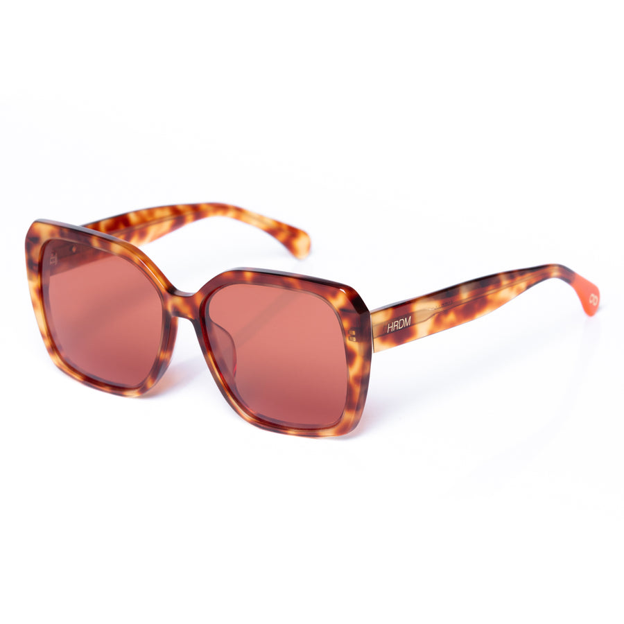 Sunglasses with tortoiseshell frame and brown lenses on a white background