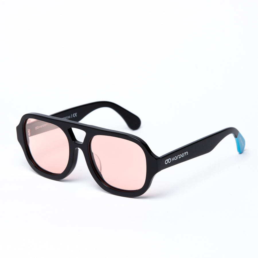 Black sunglasses with pink lenses on a white background
