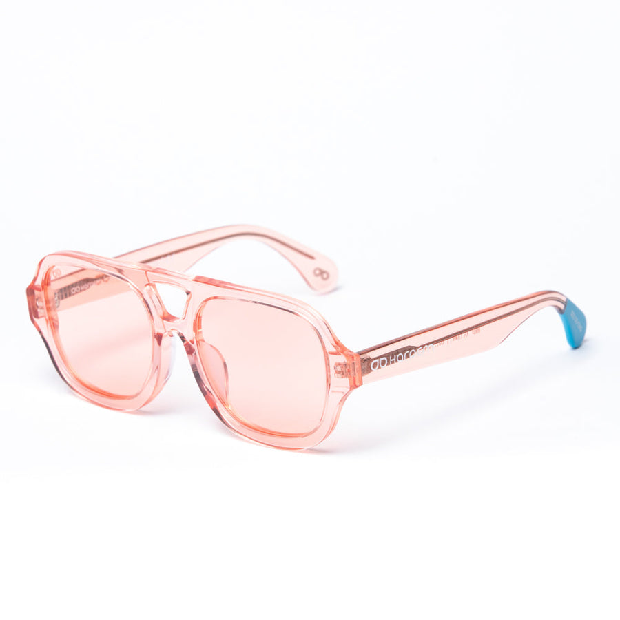 Pink sunglasses with a blue tip on a white background