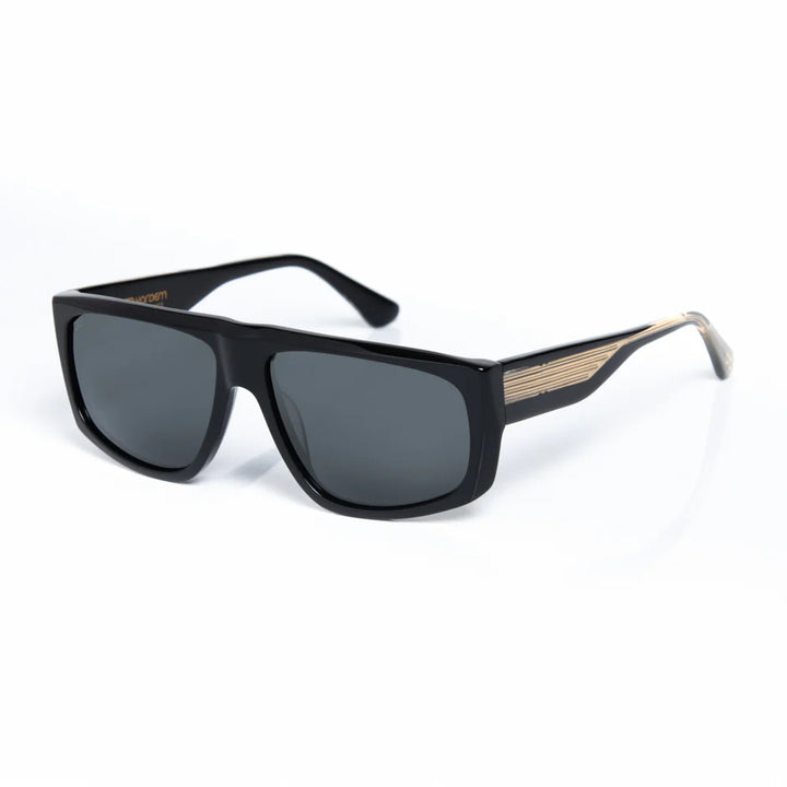 Black sunglasses with gold accents on a white background