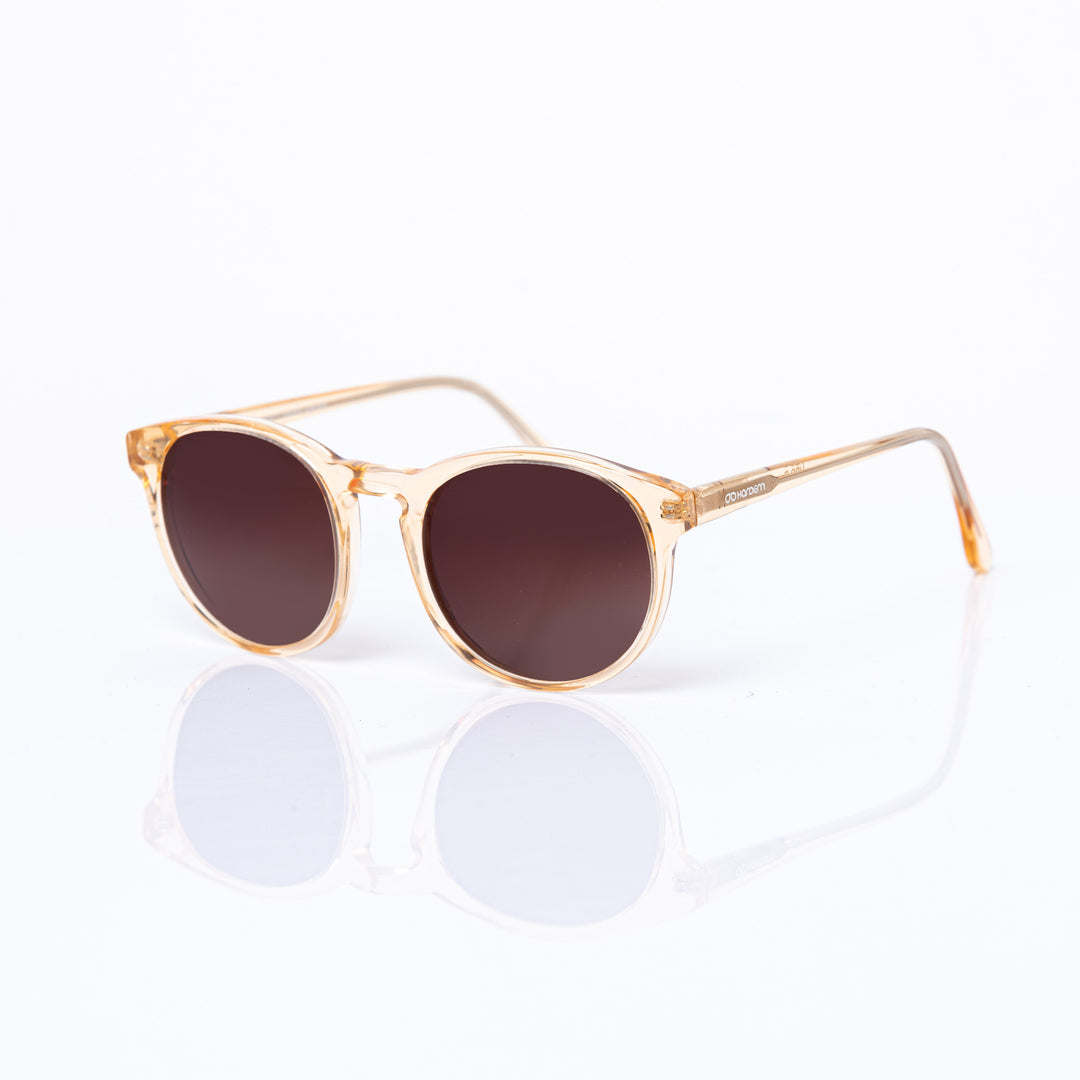 Sunglasses with a clear frame and brown lenses on a white background