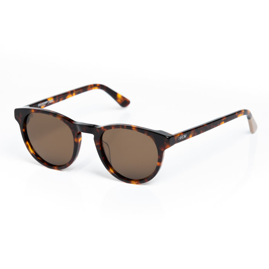 Sunglasses with tortoiseshell frame and brown lenses on a white background